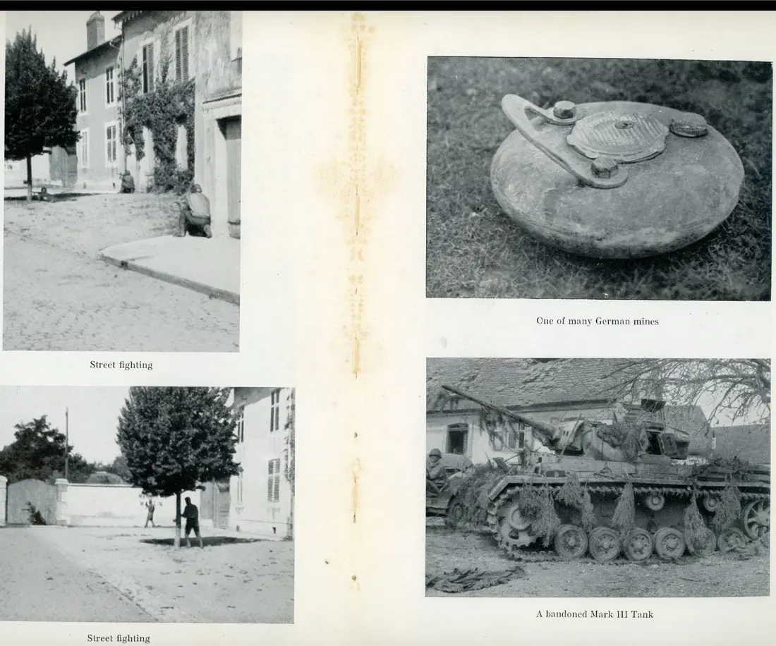 A soldier crouched on a quiet French village street