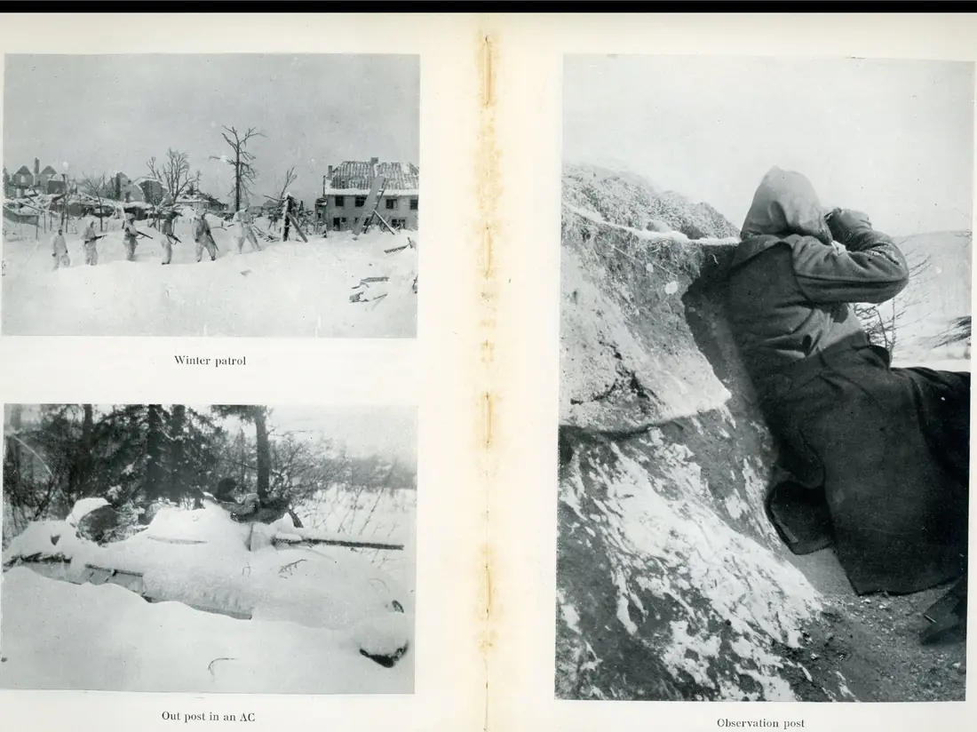 A patrol of soldiers crossing a snow-covered, shattered village